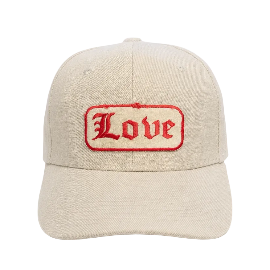 Beige cap with 'Love' embroidered in red on a white background